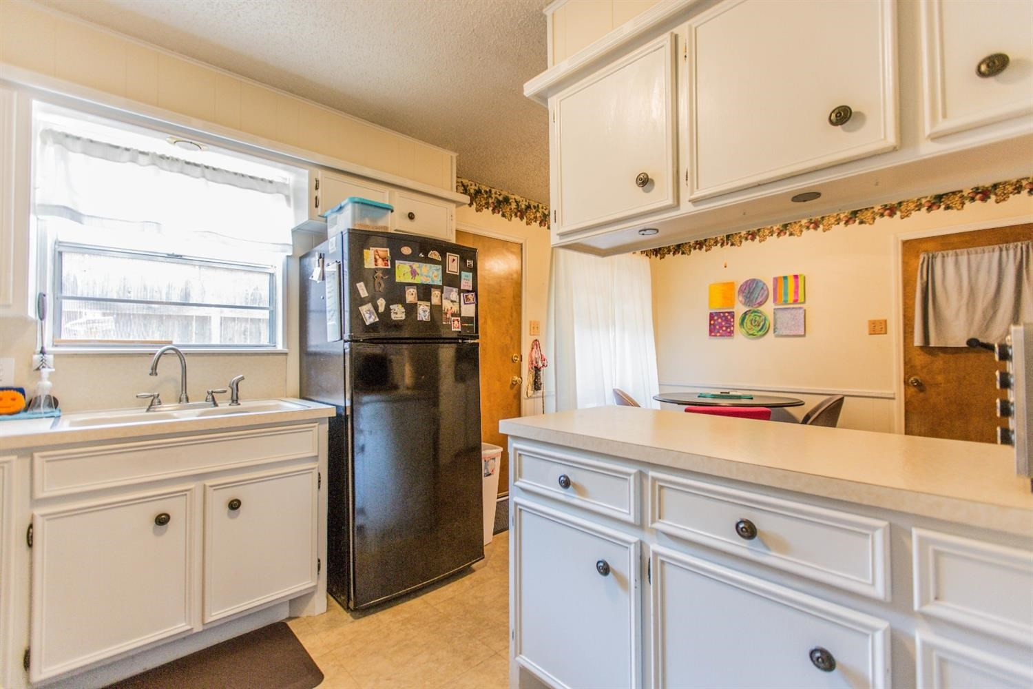 7901 Aberdeen Avenue Lubbock, TX 79424 - Photo 8 of 10 a kitchen with stainless steel appliances cabinets a window and a sink