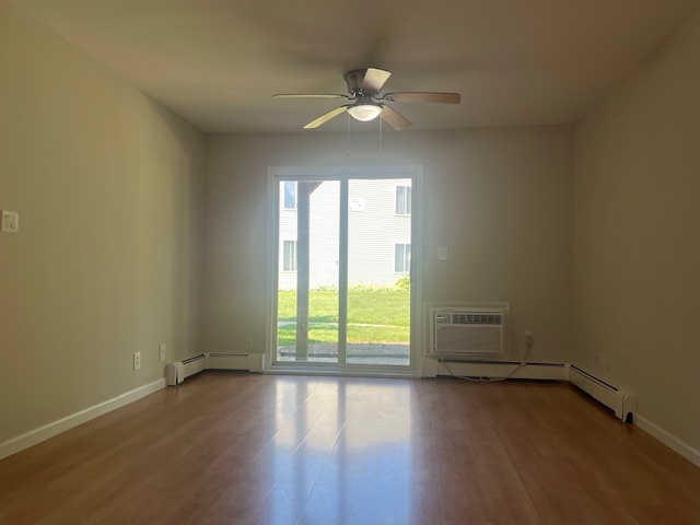 2300 Light Road, Unit 109 Oswego, IL 60543 - Photo 3 of 16 an empty room with wooden floor and windows
