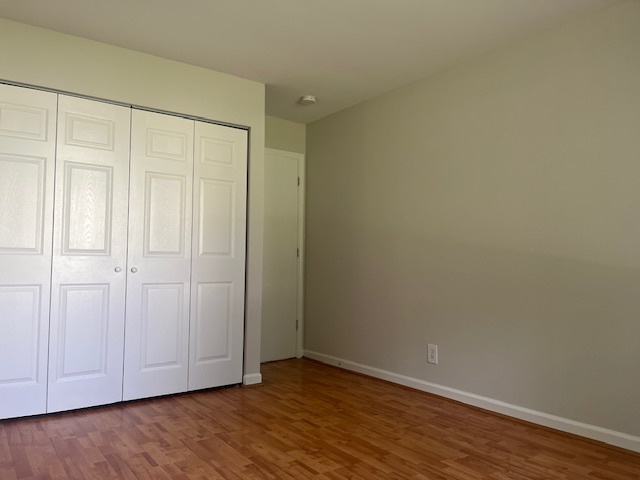 2300 Light Road, Unit 109 Oswego, IL 60543 - Photo 6 of 16 a view of an empty room with wooden floor