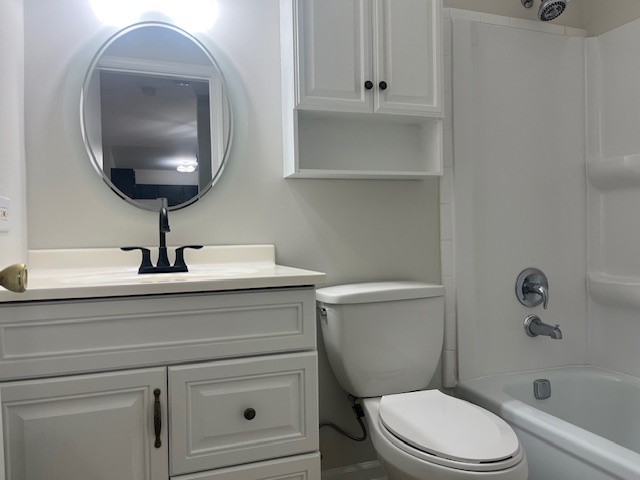 2300 Light Road, Unit 109 Oswego, IL 60543 - Photo 7 of 16 a bathroom with a sink a mirror and a toilet