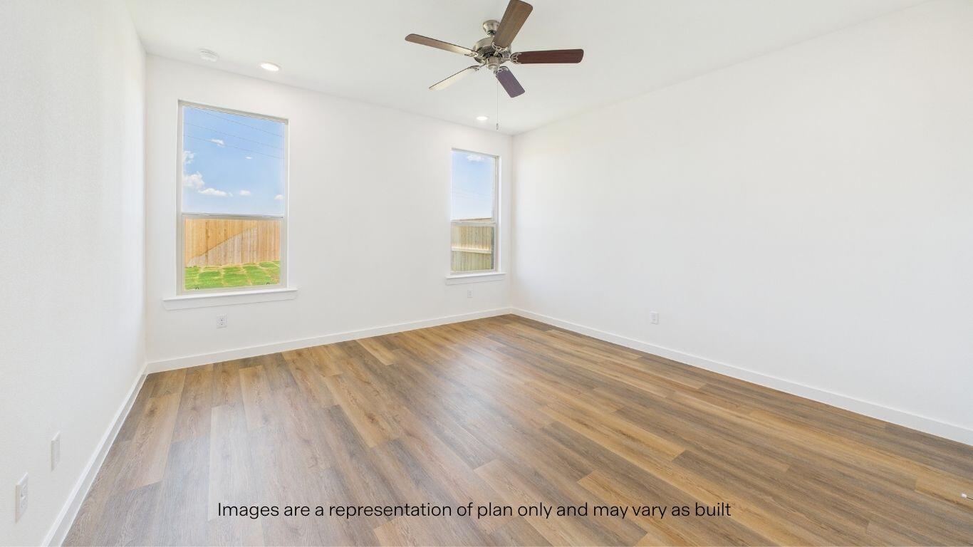 7010 53rd Street Lubbock, TX 79407 - Photo 17 of 33 an empty room with wooden floor fan and windows