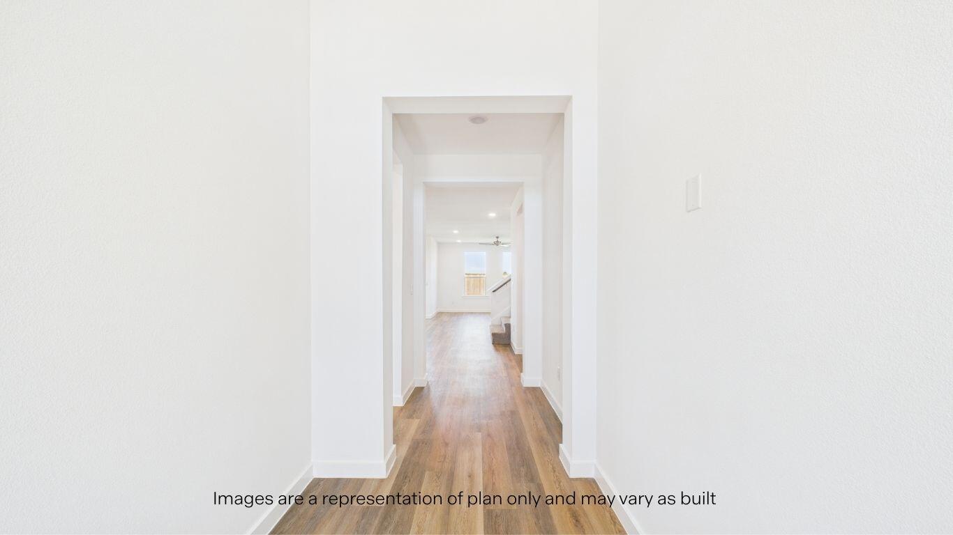 7010 53rd Street Lubbock, TX 79407 - Photo 7 of 33 a view of a hallway with wooden floor and a bathroom