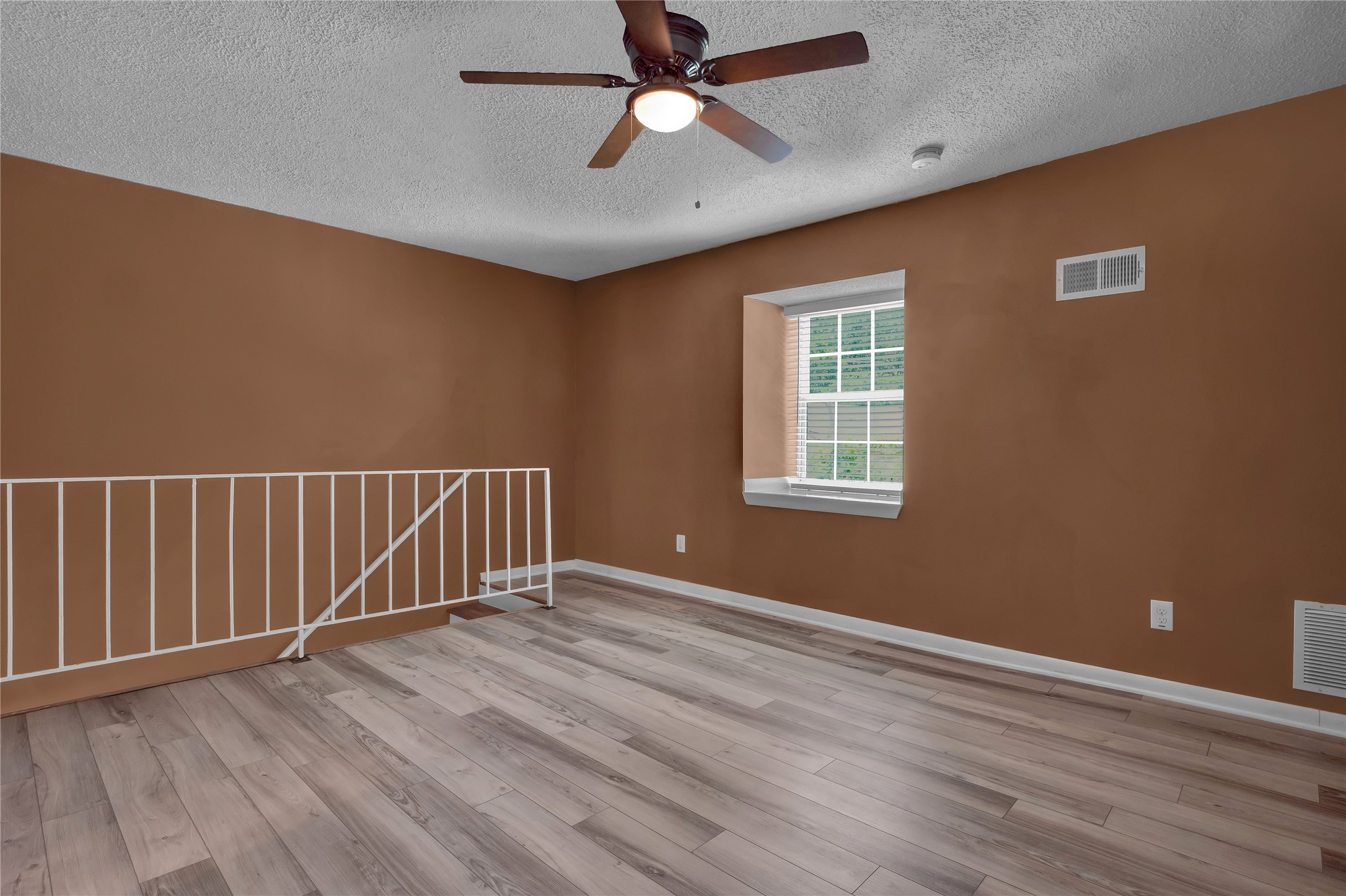 5002 Blue Spruce Circle, Unit C Austin, TX 78723 - Photo 13 of 18 a view of an empty room with wooden floor