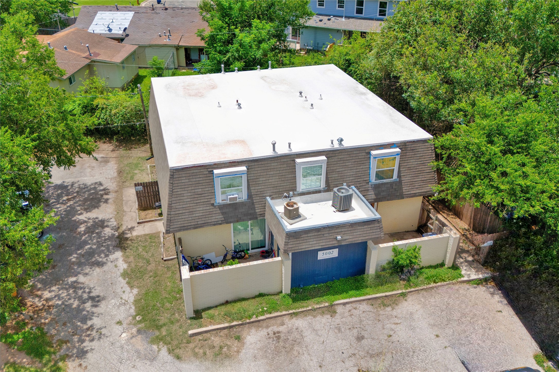 5002 Blue Spruce Circle, Unit C Austin, TX 78723 - Photo 5 of 18 an aerial view of a house with yard