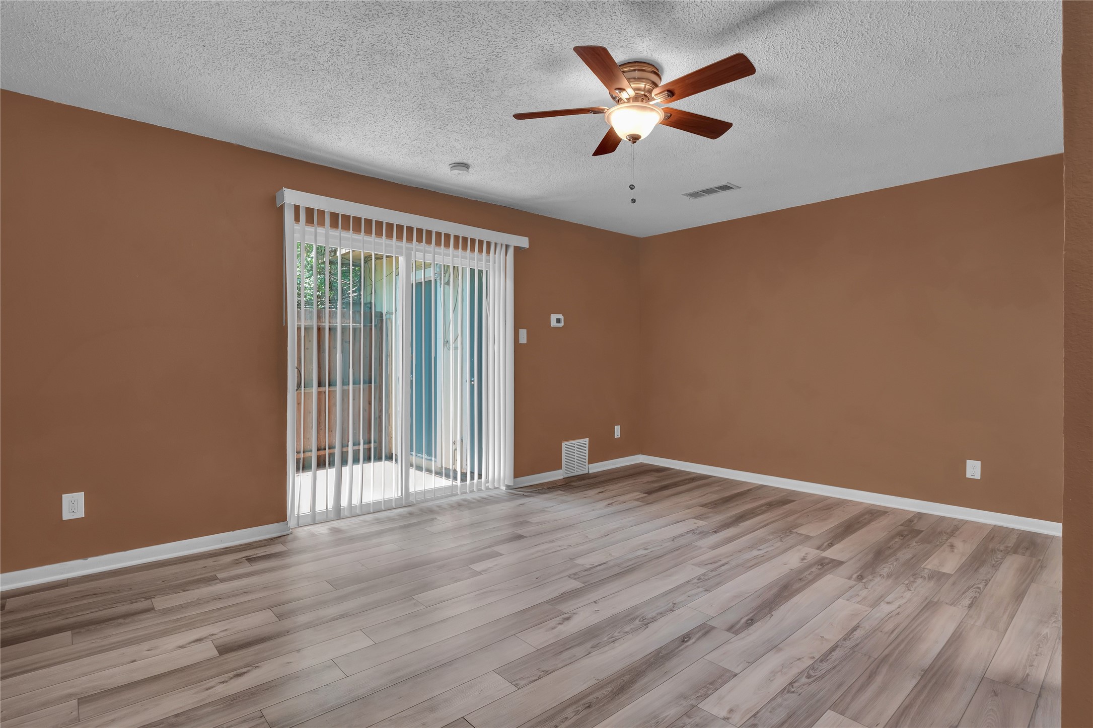 5002 Blue Spruce Circle, Unit C Austin, TX 78723 - Photo 8 of 18 wooden floor in an empty room with a window