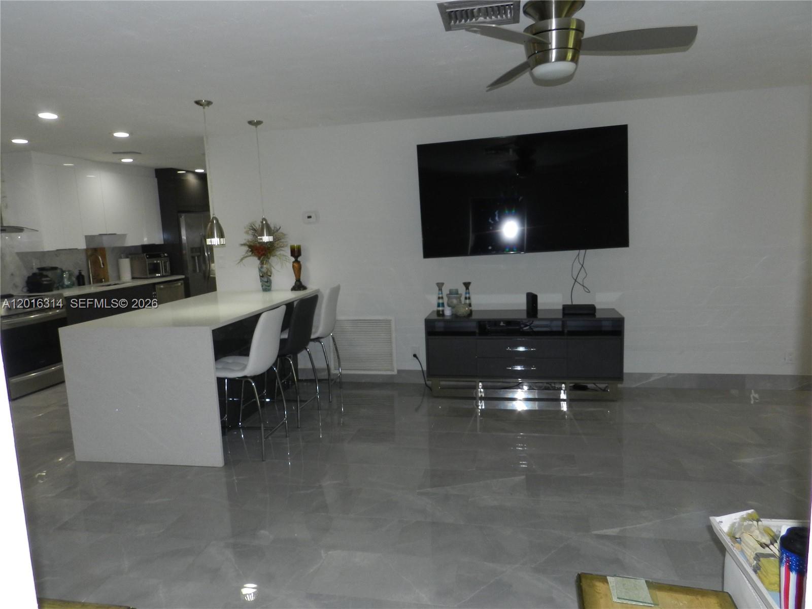305 Northwest 42nd Street Boca Raton, FL 33431 - Photo 7 of 31 a kitchen with a sink and a microwave
