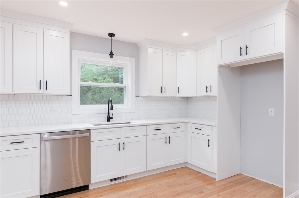 36 Hiland Road Charlton, MA 01507 - Photo 2 of 38 a kitchen with white cabinets appliances and a window