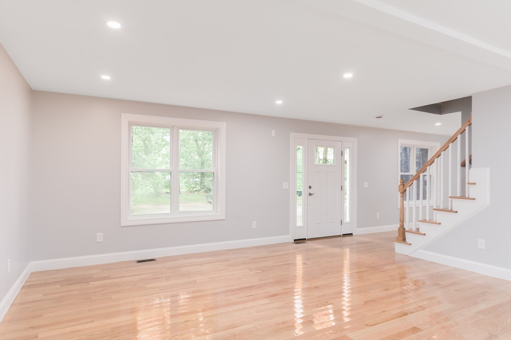 36 Hiland Road Charlton, MA 01507 - Photo 8 of 38 a view of an empty room with wooden floor and a window