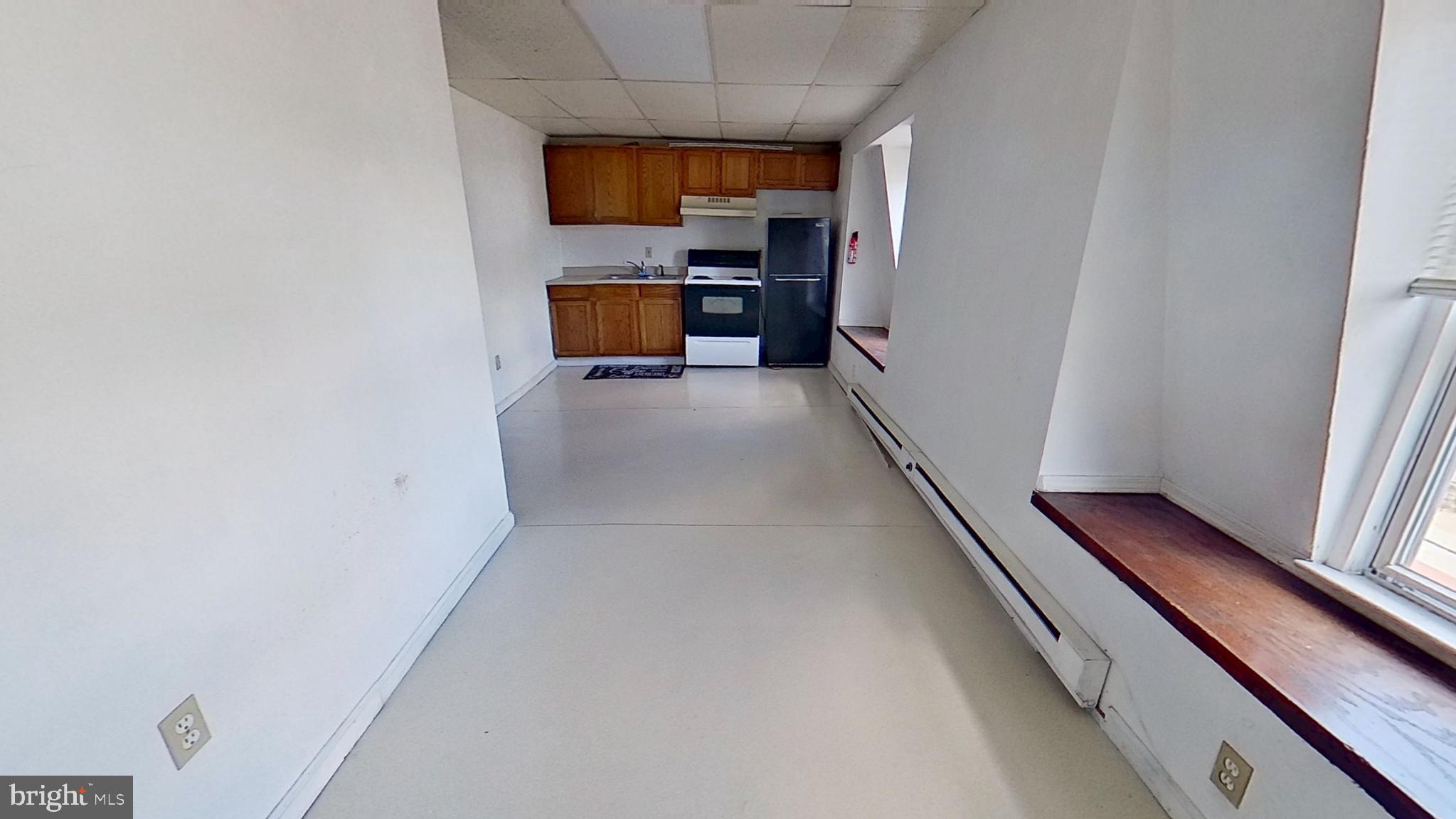 128 South Main Street, Unit 3 Spring Grove, PA 17362 - Photo 3 of 4 a view of kitchen with furniture and wooden floor