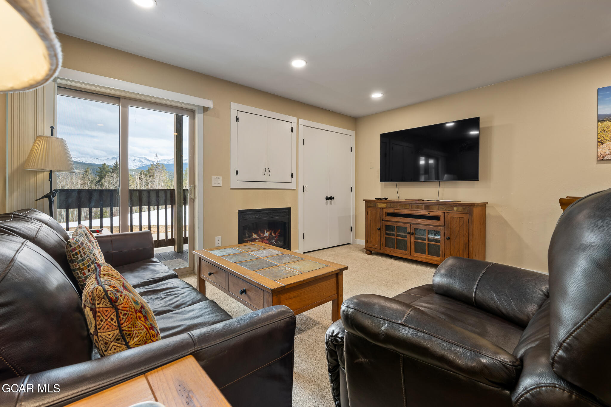 490 Kings Crossing Road, Unit 611 Winter Park, CO 80482 - Photo 11 of 39 a living room with furniture a flat screen tv and a fireplace