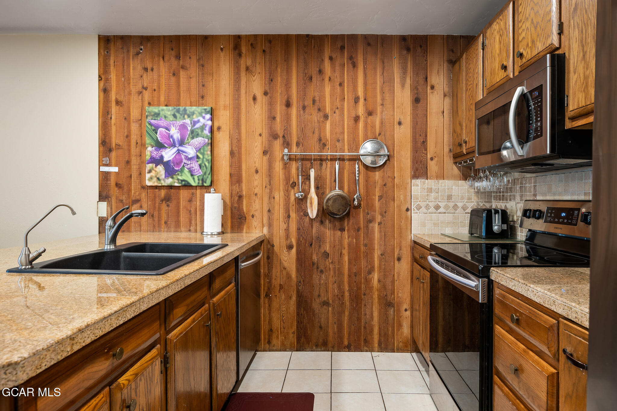 490 Kings Crossing Road, Unit 611 Winter Park, CO 80482 - Photo 13 of 39 a kitchen with stainless steel appliances granite countertop a sink stove and refrigerator