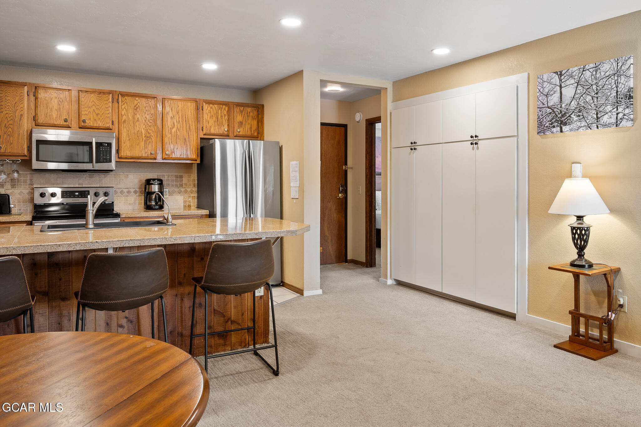 490 Kings Crossing Road, Unit 611 Winter Park, CO 80482 - Photo 16 of 39 a kitchen with stainless steel appliances granite countertop a sink refrigerator and microwave