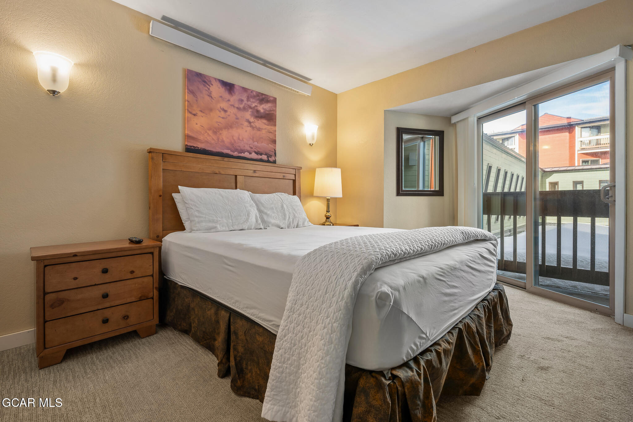 490 Kings Crossing Road, Unit 611 Winter Park, CO 80482 - Photo 20 of 39 a bedroom with a bed and a painting on the wall