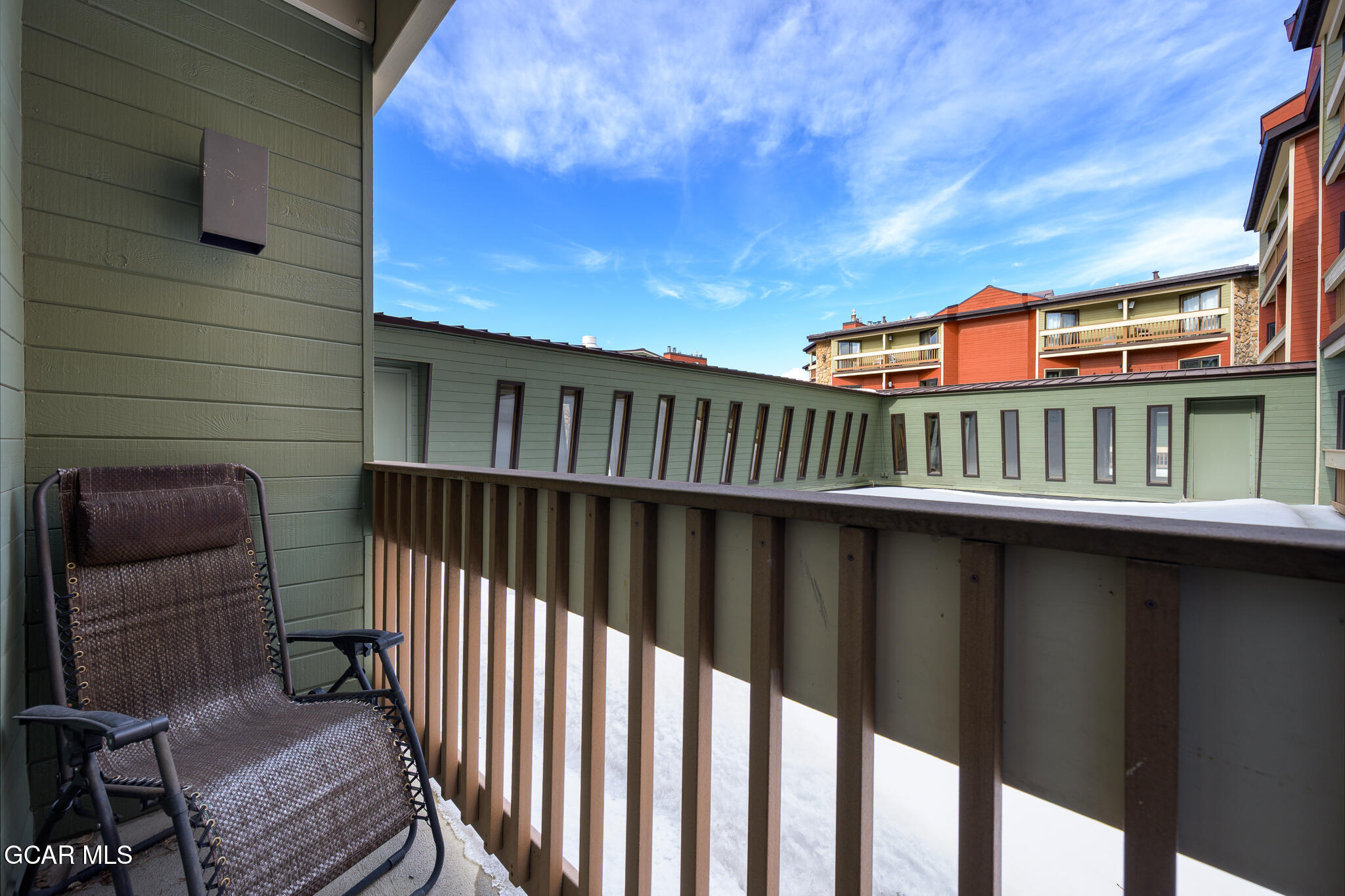 490 Kings Crossing Road, Unit 611 Winter Park, CO 80482 - Photo 26 of 39 a balcony with two chairs and a table