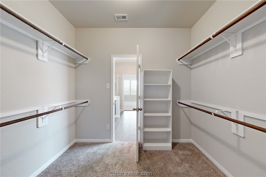5764 Paseo Place Bryan, TX 77807 - Photo 15 of 35 Large primary walk in closet with built ins.