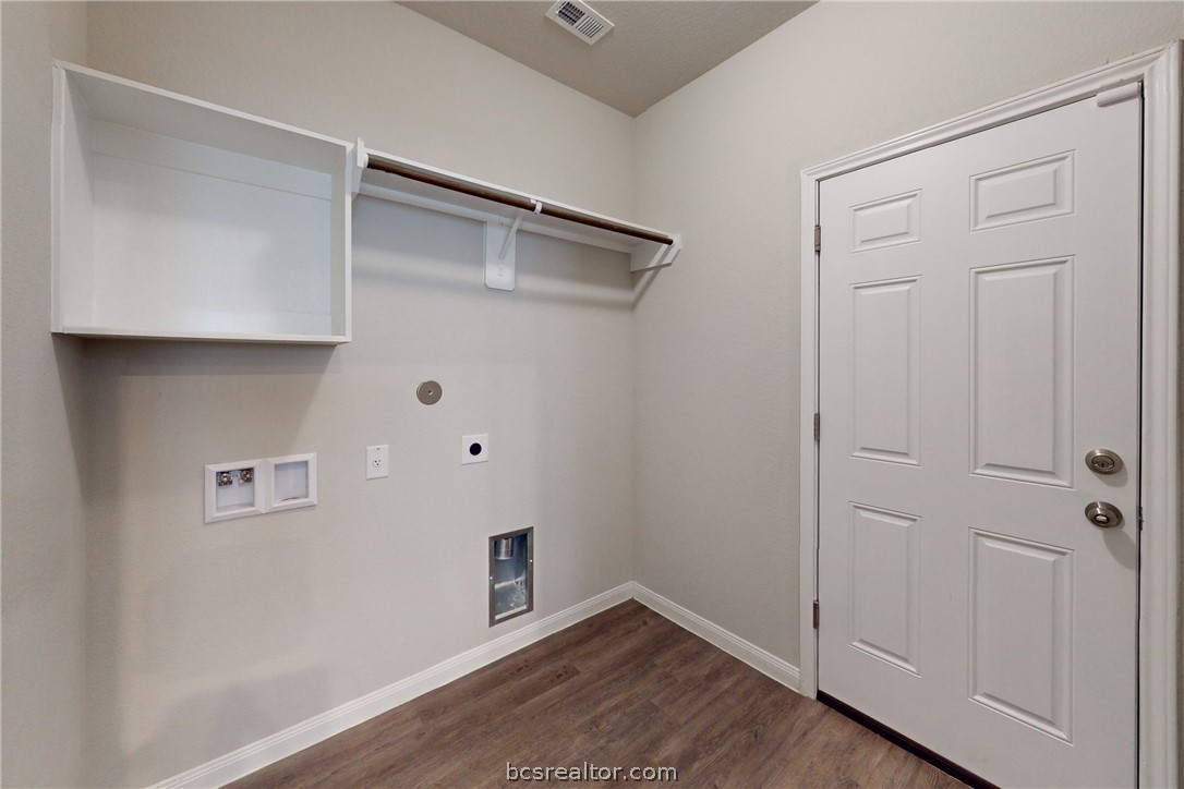 5764 Paseo Place Bryan, TX 77807 - Photo 18 of 35 Laundry room with built in shelves and hanging rod. Garage door is on the right.