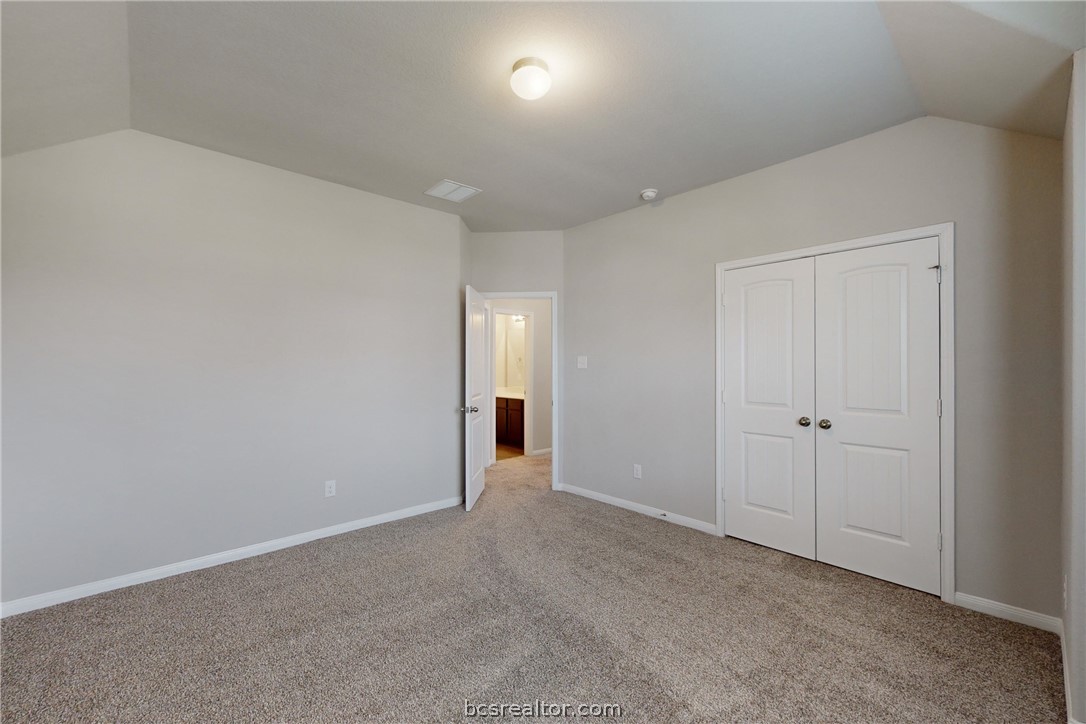 5764 Paseo Place Bryan, TX 77807 - Photo 23 of 35 Left Secondary Bedroom with large closet.