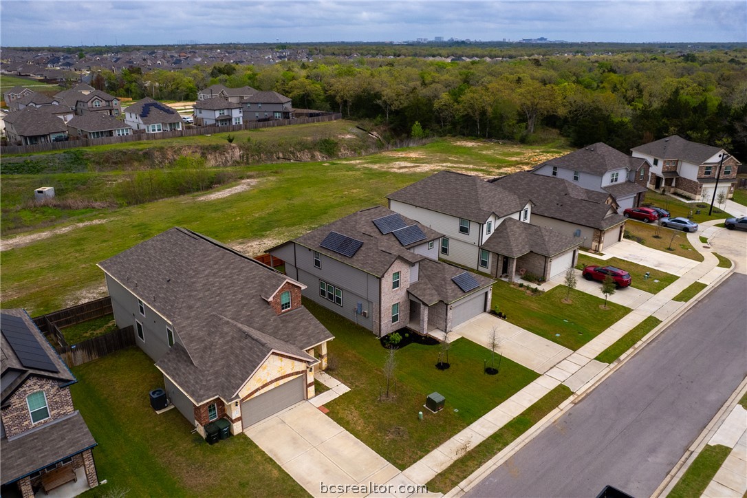5764 Paseo Place Bryan, TX 77807 - Photo 33 of 35 Green space behind the house that leads to the wooded neighboring tract of land. Kyle Field and Texas A&M main campus are shining through the trees in the background, whoop!