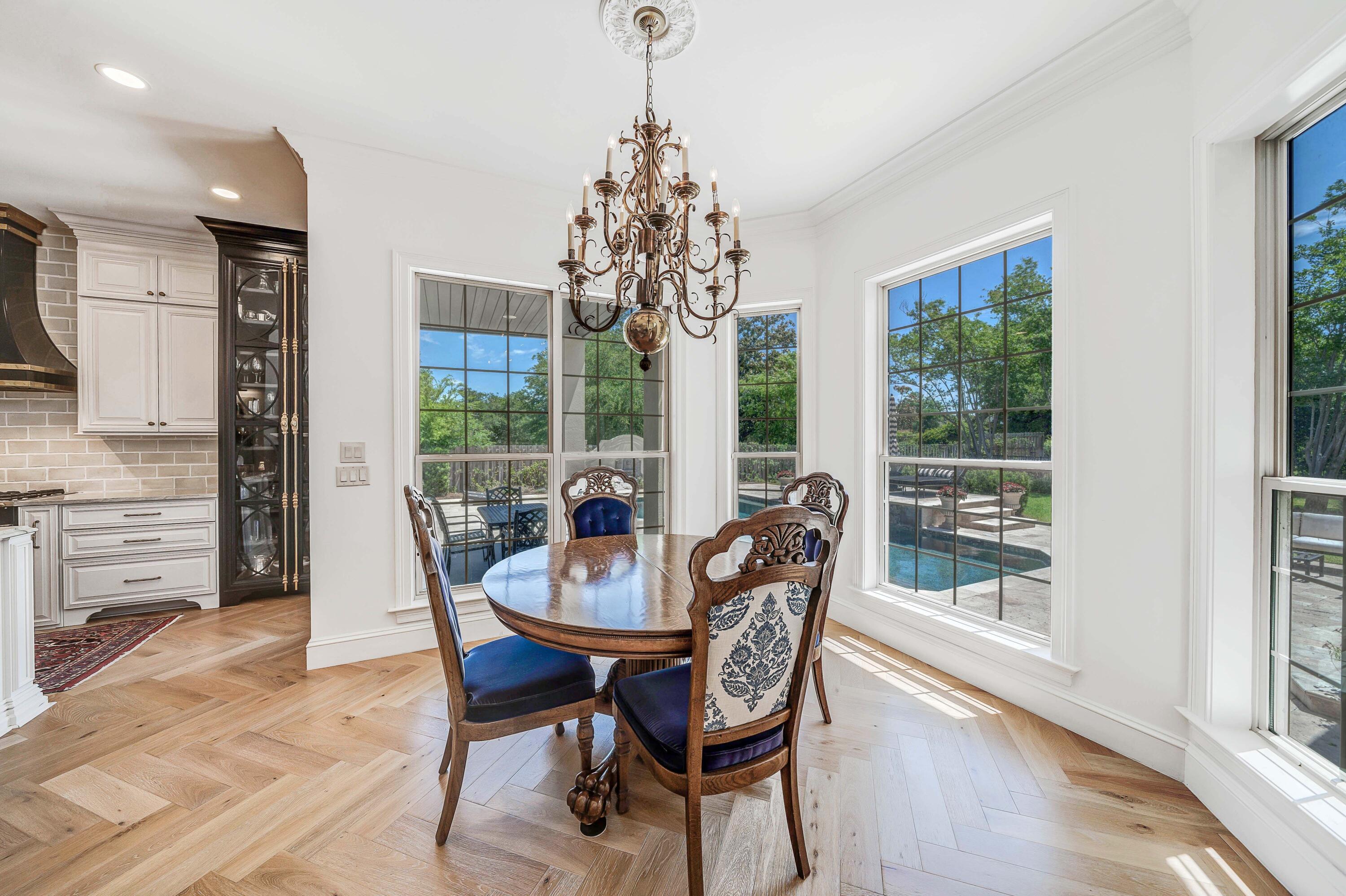 3417 Dragon's Ridge Road Panama City Beach, FL 32408 - Photo 24 of 69 a dining room with furniture large windows and a chandelier
