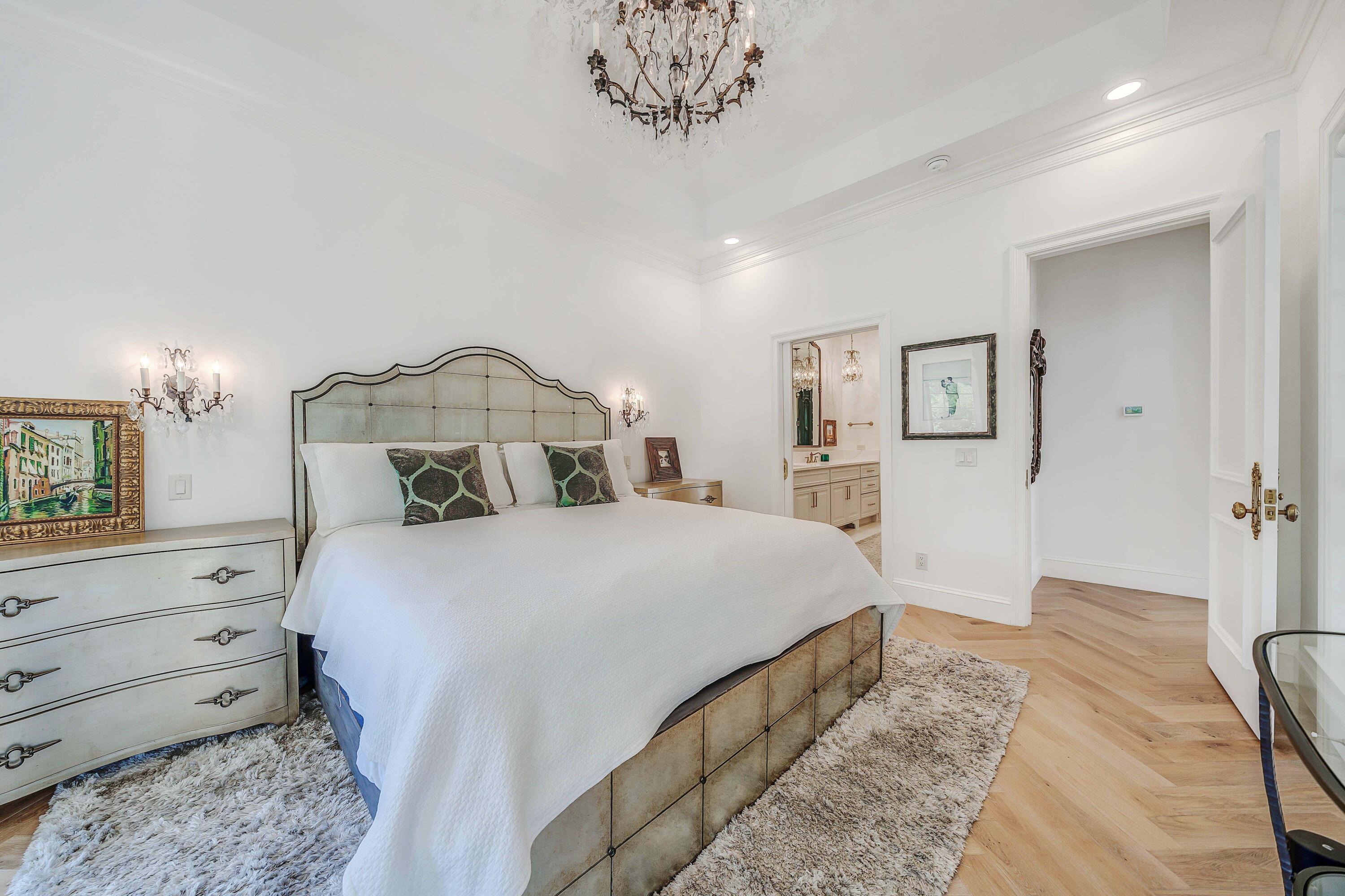3417 Dragon's Ridge Road Panama City Beach, FL 32408 - Photo 31 of 69 a bedroom with a bed and a chandelier