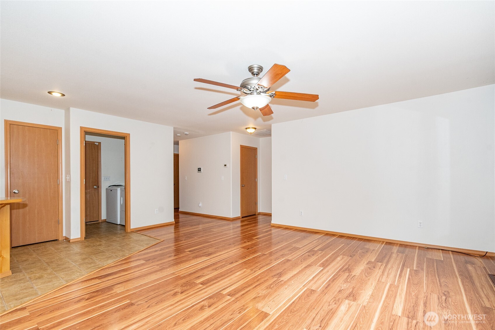 241 Parkside Loop Napavine, WA 98532 - Photo 18 of 34 a view of an empty room with wooden floor and a ceiling fan