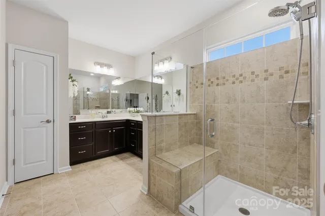 a bathroom with a double vanity sink toilet and shower