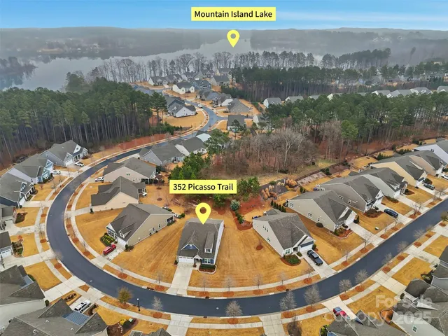 an aerial view of a house with a swimming pool