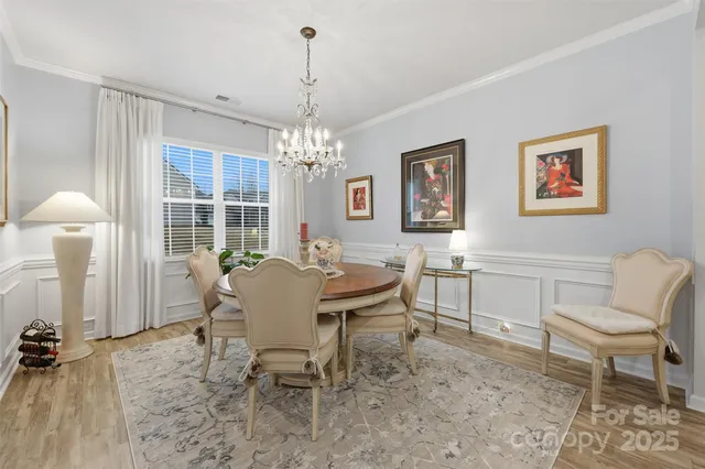 a view of a dining room with furniture and chandelier
