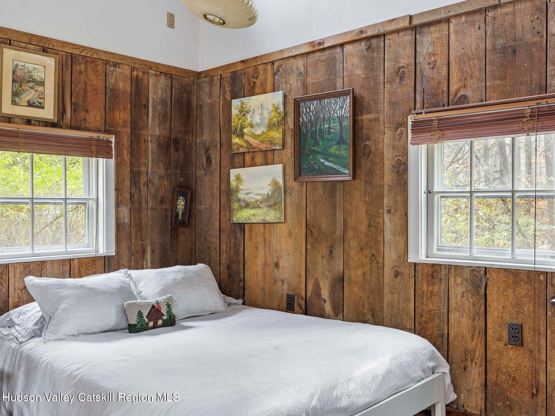 259 Silver Hollow Road Willow, NY 12495 - Photo 11 of 28 a bedroom with a bed window and doors