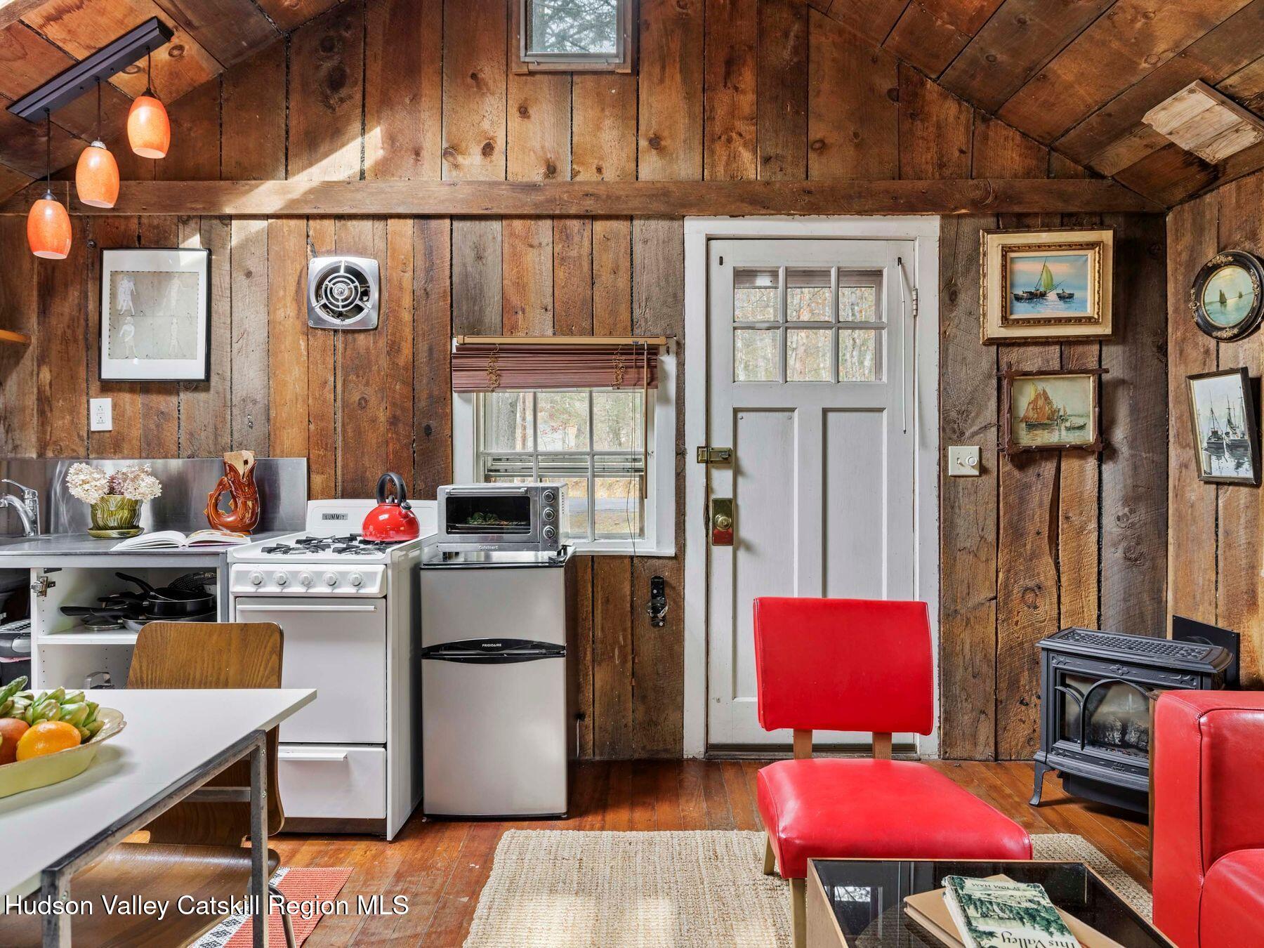 259 Silver Hollow Road Willow, NY 12495 - Photo 13 of 28 a kitchen with a refrigerator and a stove top oven
