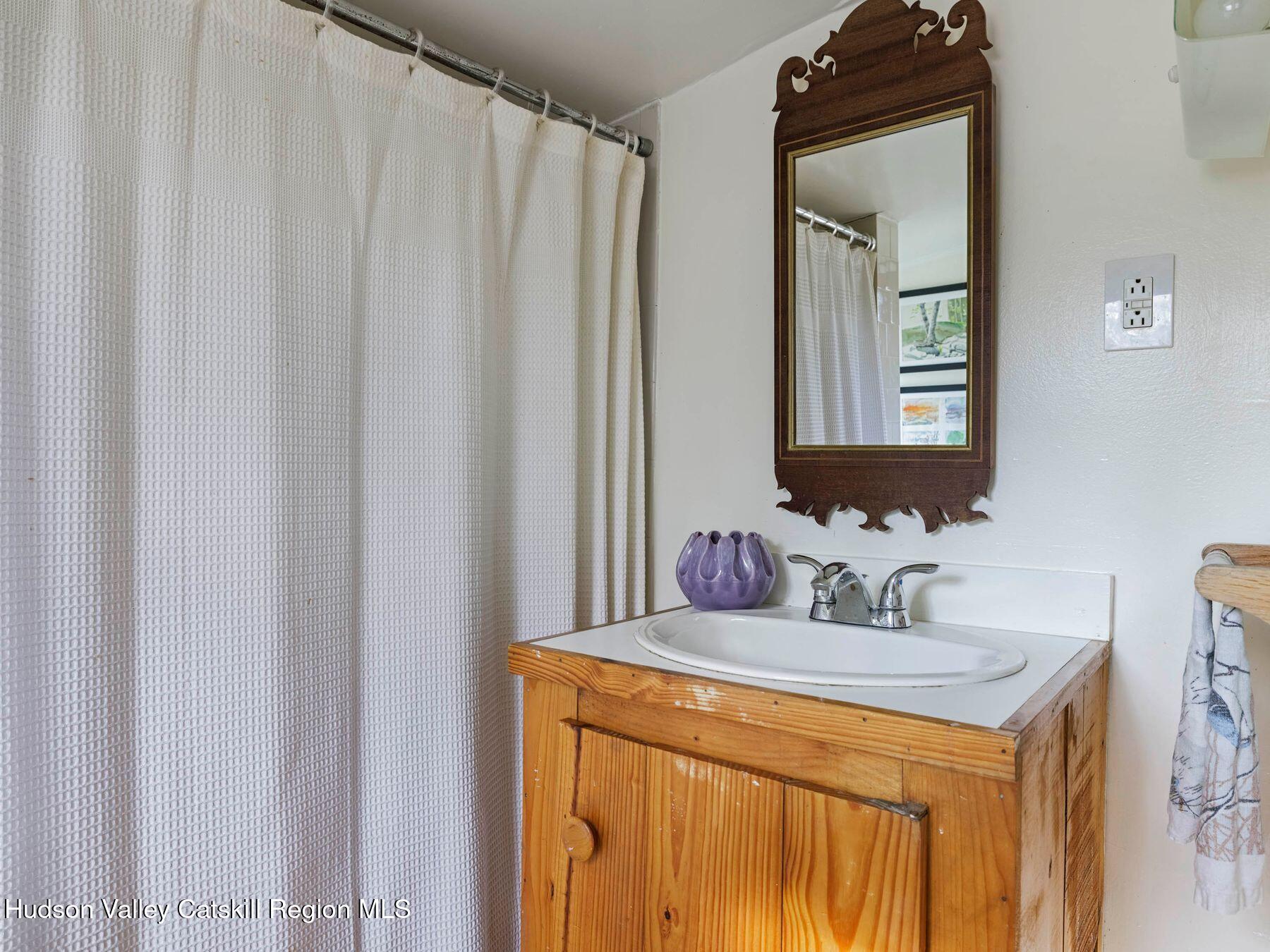 259 Silver Hollow Road Willow, NY 12495 - Photo 23 of 28 a bathroom with a sink and a mirror
