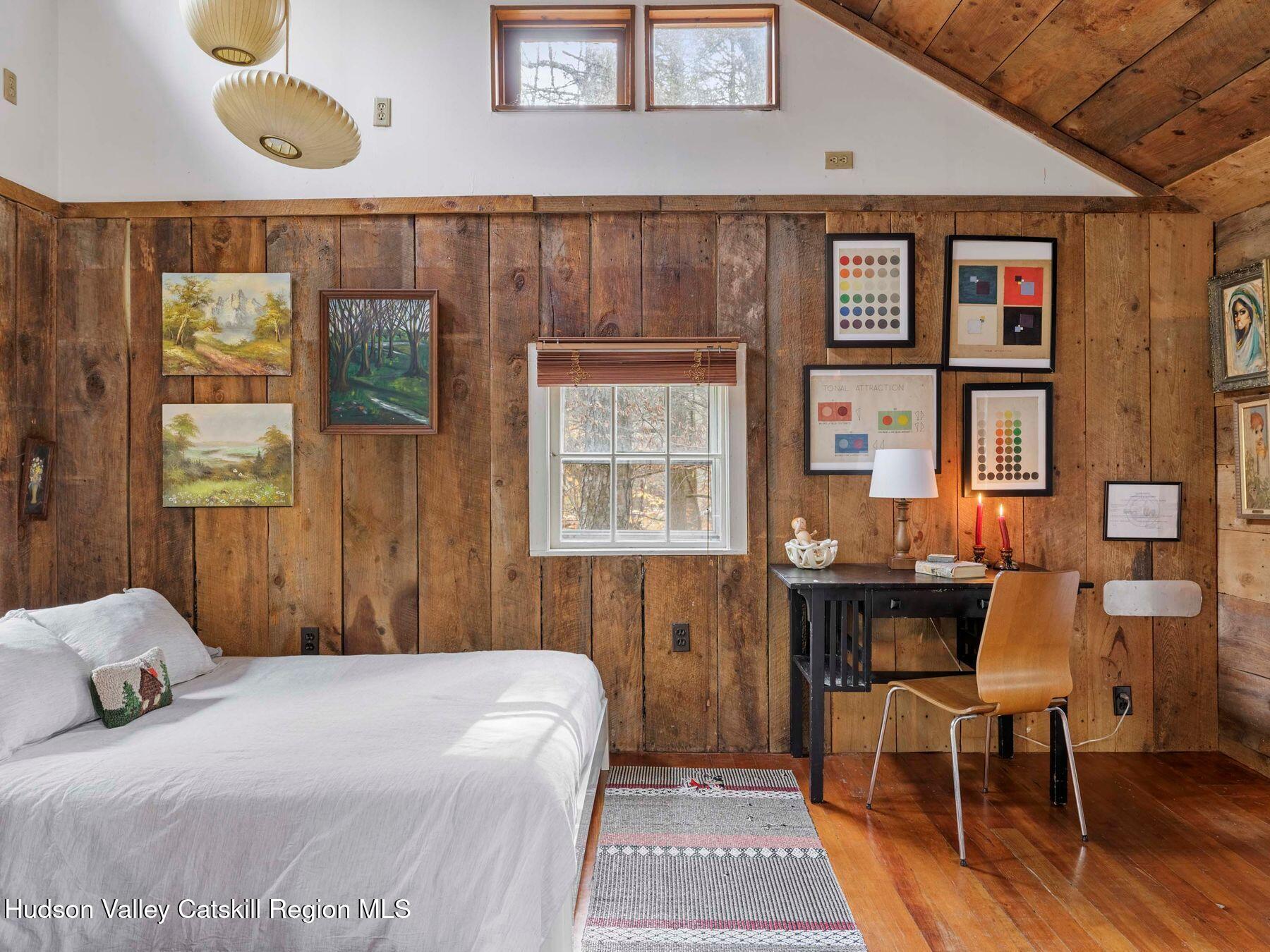 259 Silver Hollow Road Willow, NY 12495 - Photo 9 of 28 a bedroom with a bed and a table in it