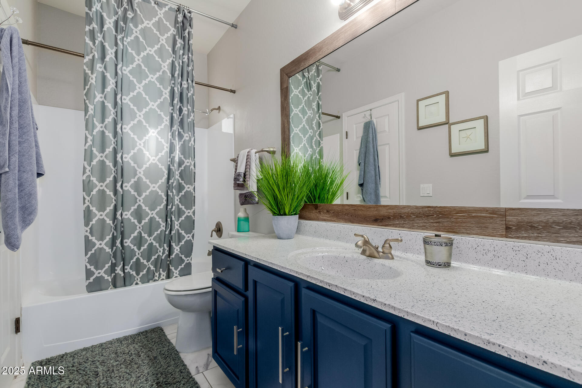 45247 West Jack Rabbit Trail Maricopa, AZ 85139 - Photo 23 of 46 a bathroom with a granite countertop sink and a mirror