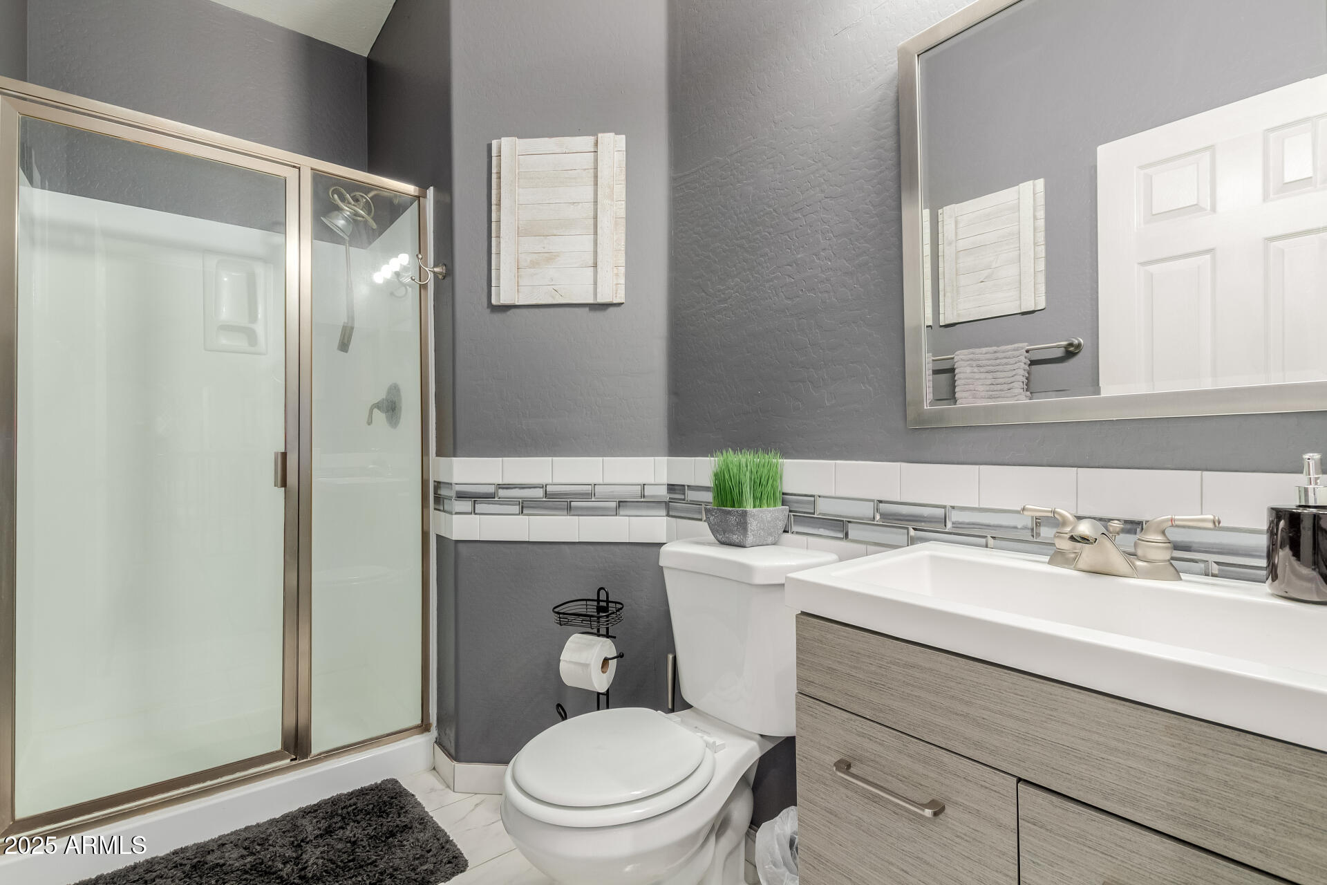 45247 West Jack Rabbit Trail Maricopa, AZ 85139 - Photo 26 of 46 a bathroom with a sink a toilet and shower