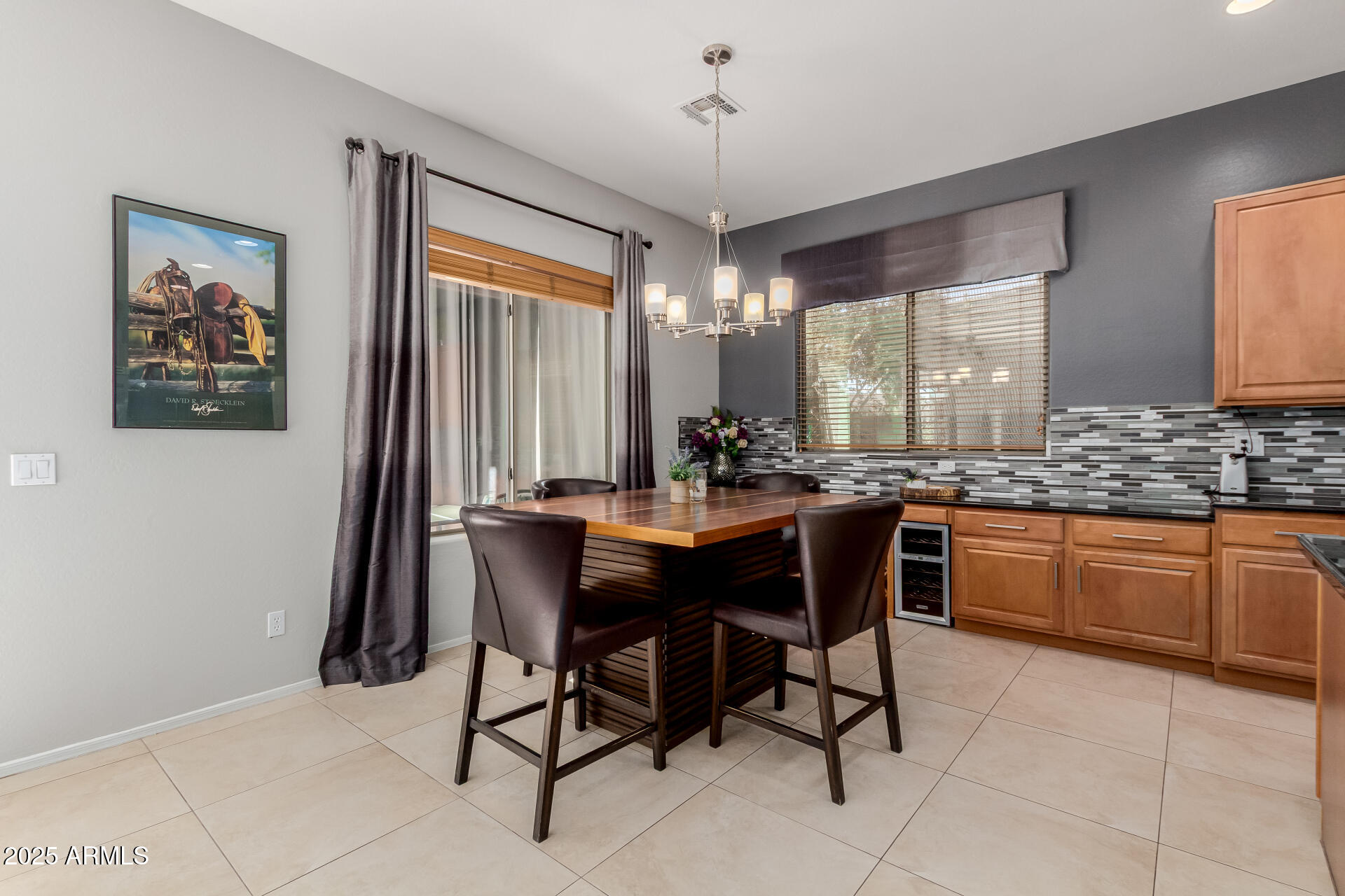45247 West Jack Rabbit Trail Maricopa, AZ 85139 - Photo 10 of 46 a kitchen with a sink dining table and chairs
