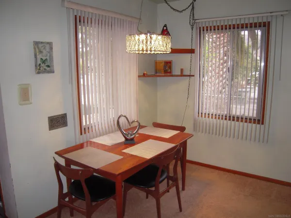 a view of a dining room with furniture and window