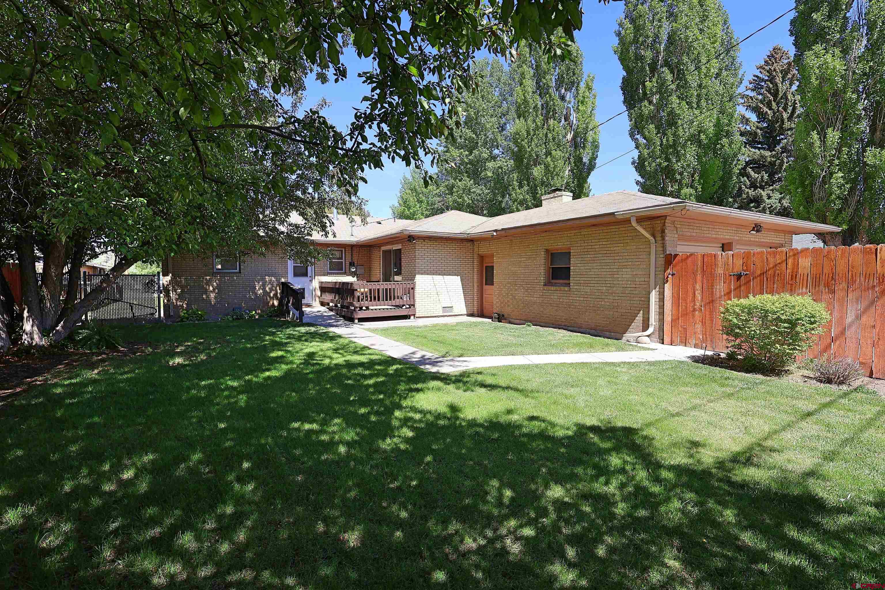 96 El Rio Drive Alamosa, CO 81101 - Photo 13 of 18 a view of a house with a backyard