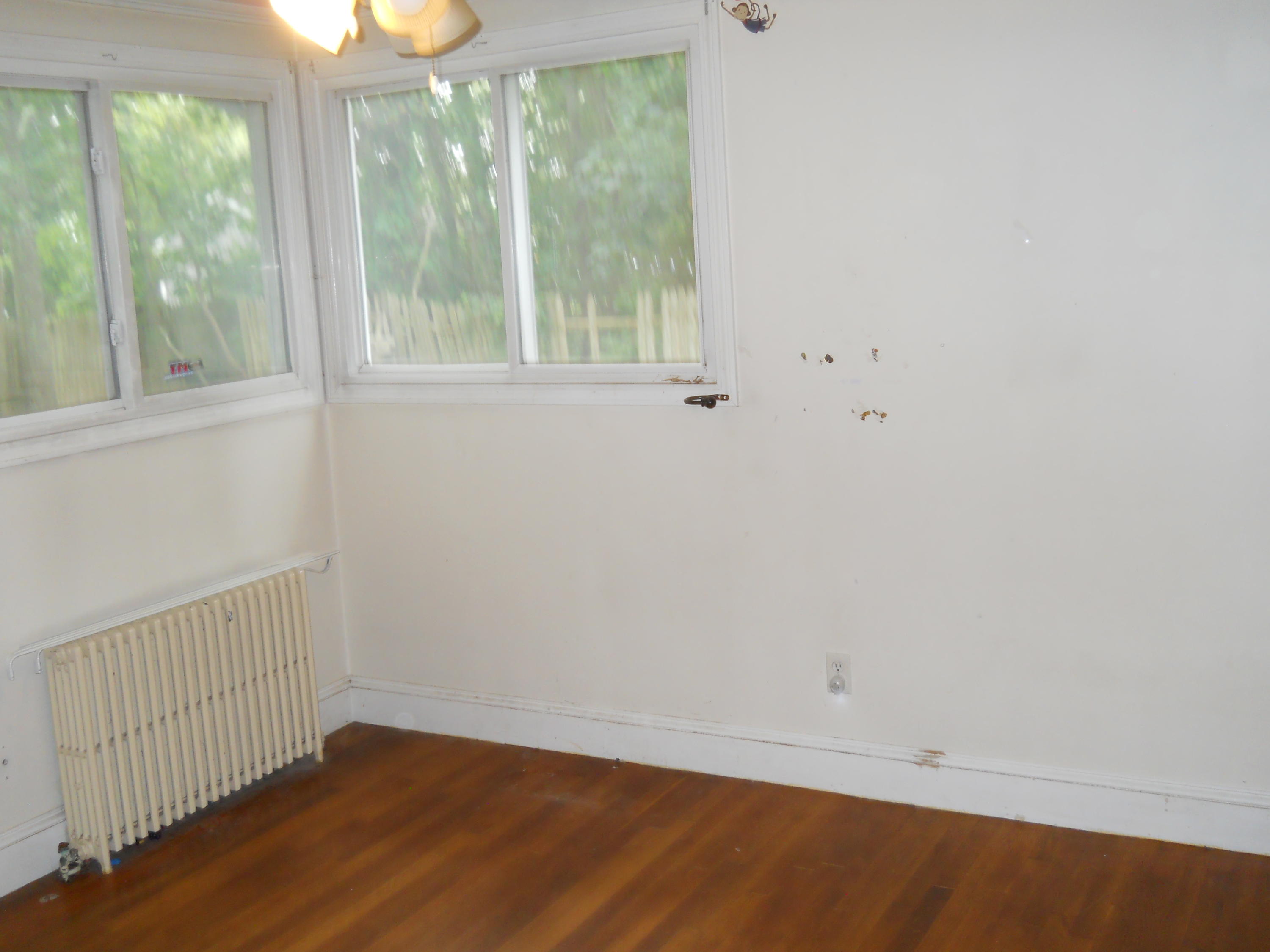 30 Dunns Pond Road Hyannis, MA 02601 - Photo 19 of 30 an empty room with wooden floor and windows