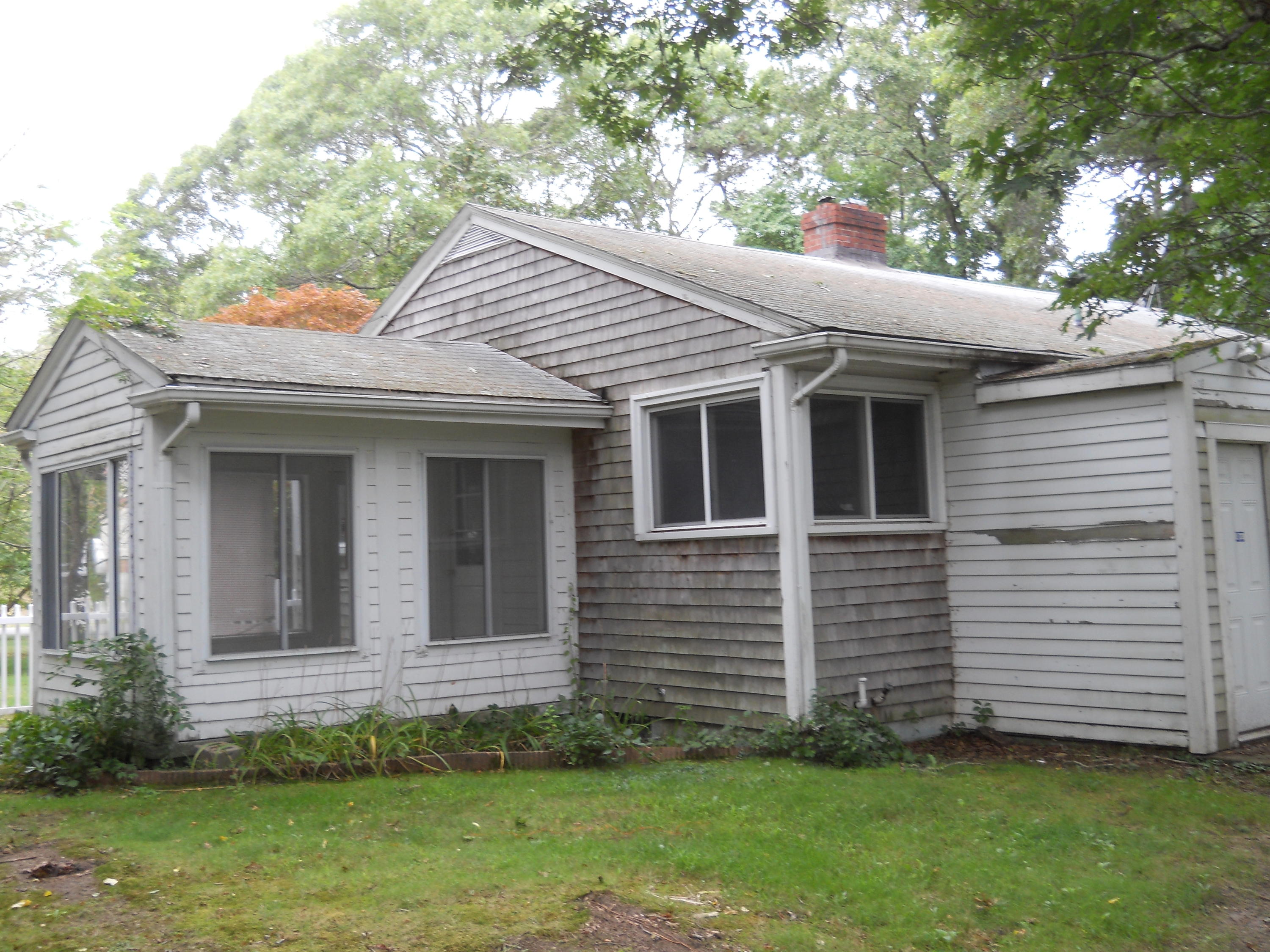 30 Dunns Pond Road Hyannis, MA 02601 - Photo 6 of 30 a view of a white house with a small yard and a large tree