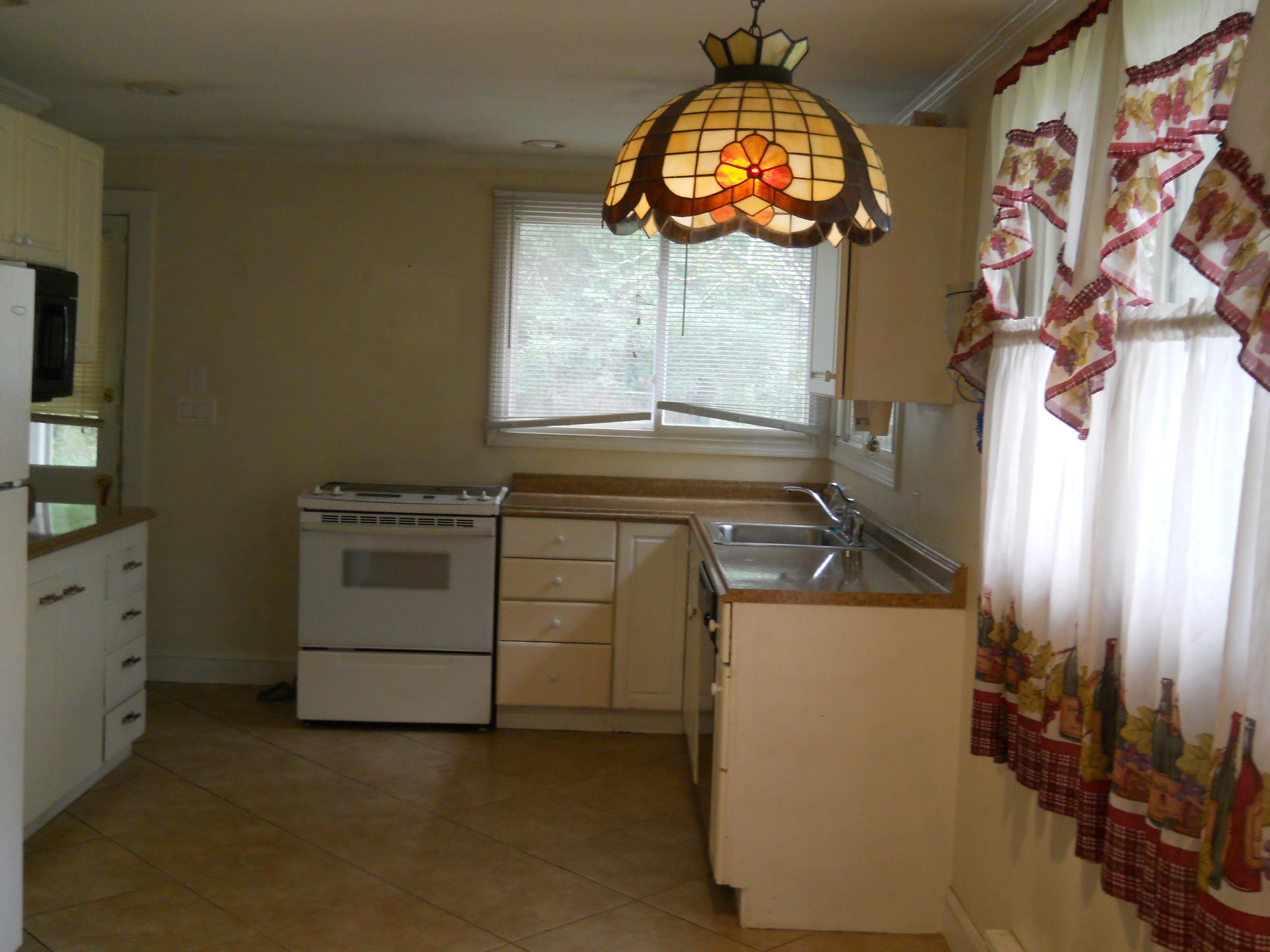 30 Dunns Pond Road Hyannis, MA 02601 - Photo 10 of 30 a kitchen with a stove and a clock