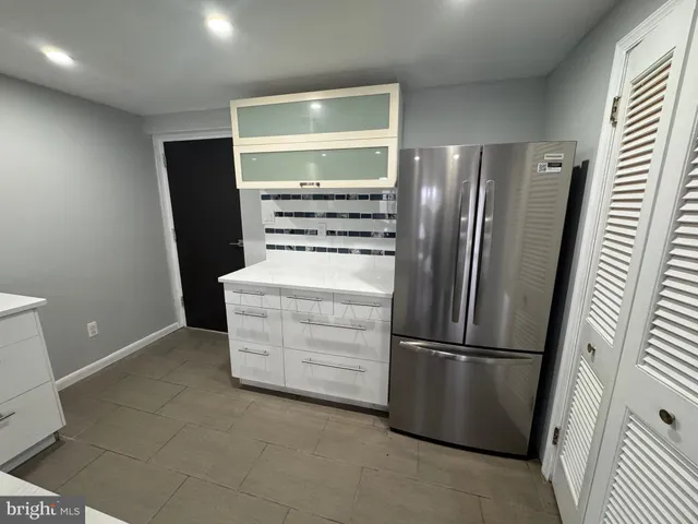 an empty room with wooden floor and closet