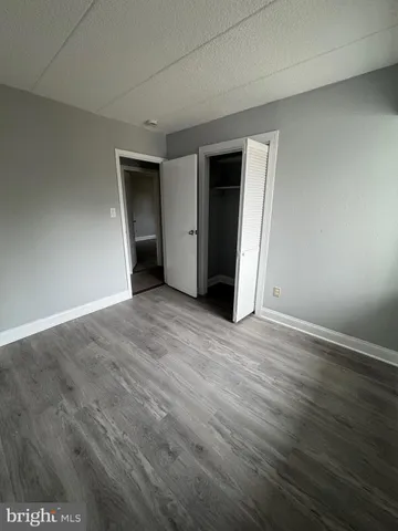 a view of a room with wooden floor and white walls