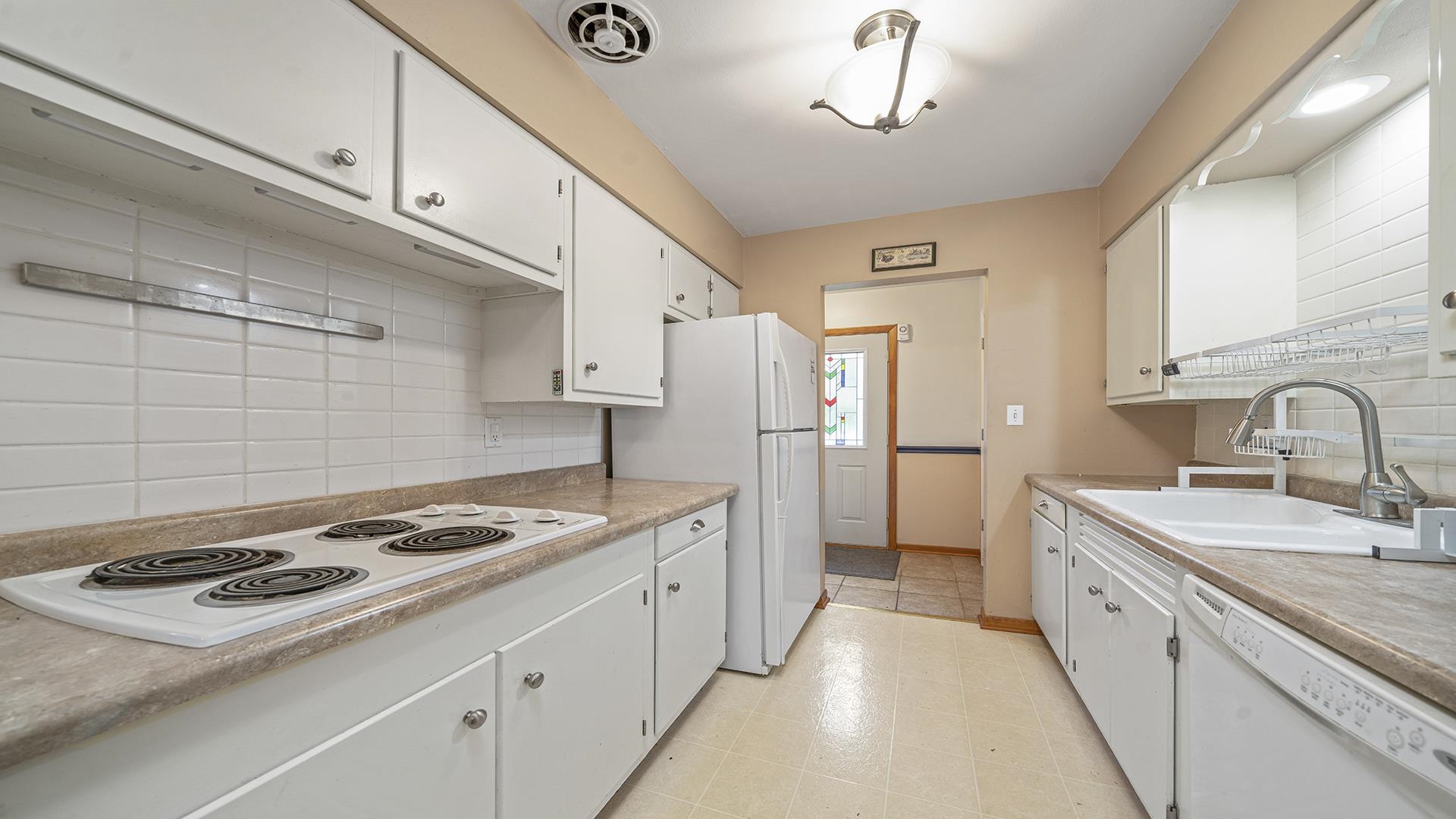 5001 Mohawk Road Rockford, IL 61107 - Photo 12 of 32 a kitchen with stainless steel appliances a sink stove and refrigerator
