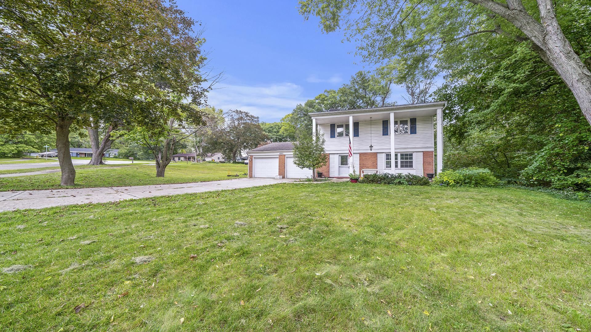 5001 Mohawk Road Rockford, IL 61107 - Photo 2 of 32 a view of a house with a big yard and large trees