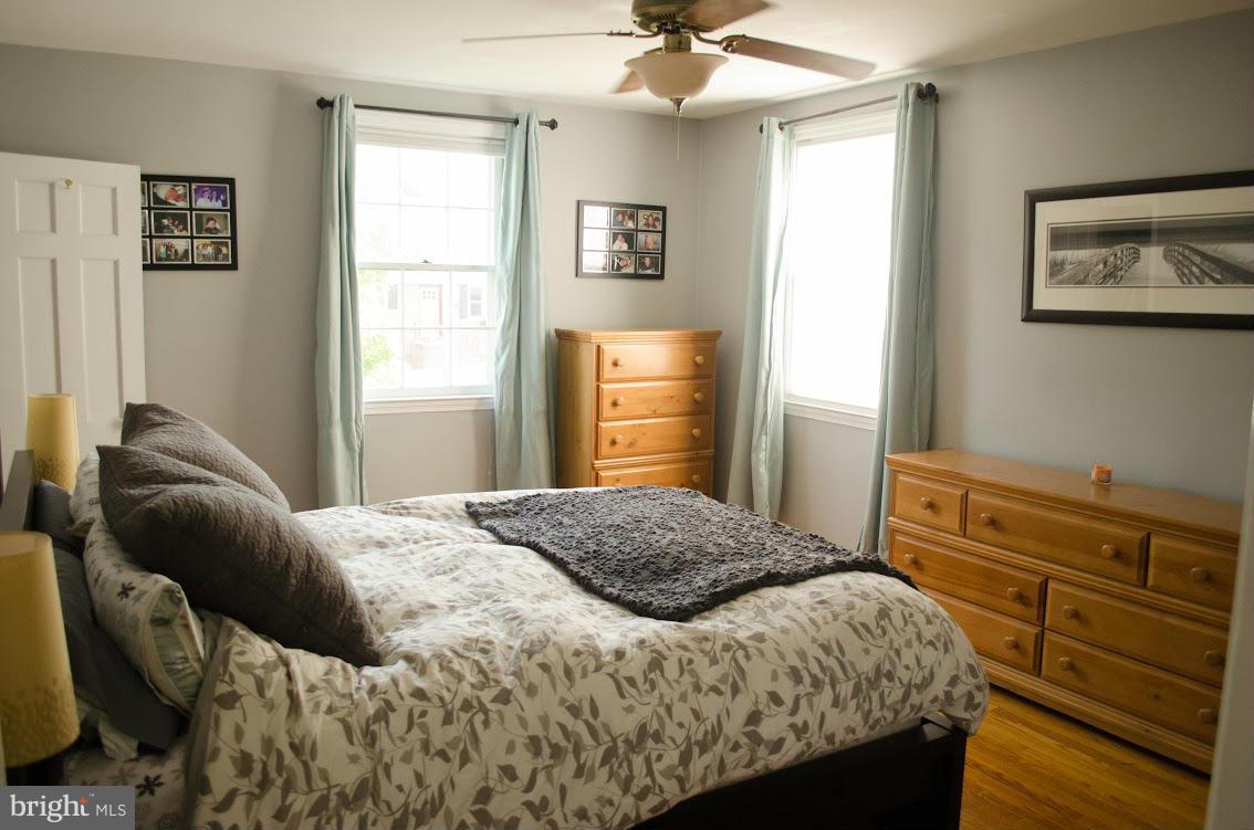 514 Windwood Road Baltimore, MD 21212 - Photo 16 of 18 a bedroom with a bed and wooden floor