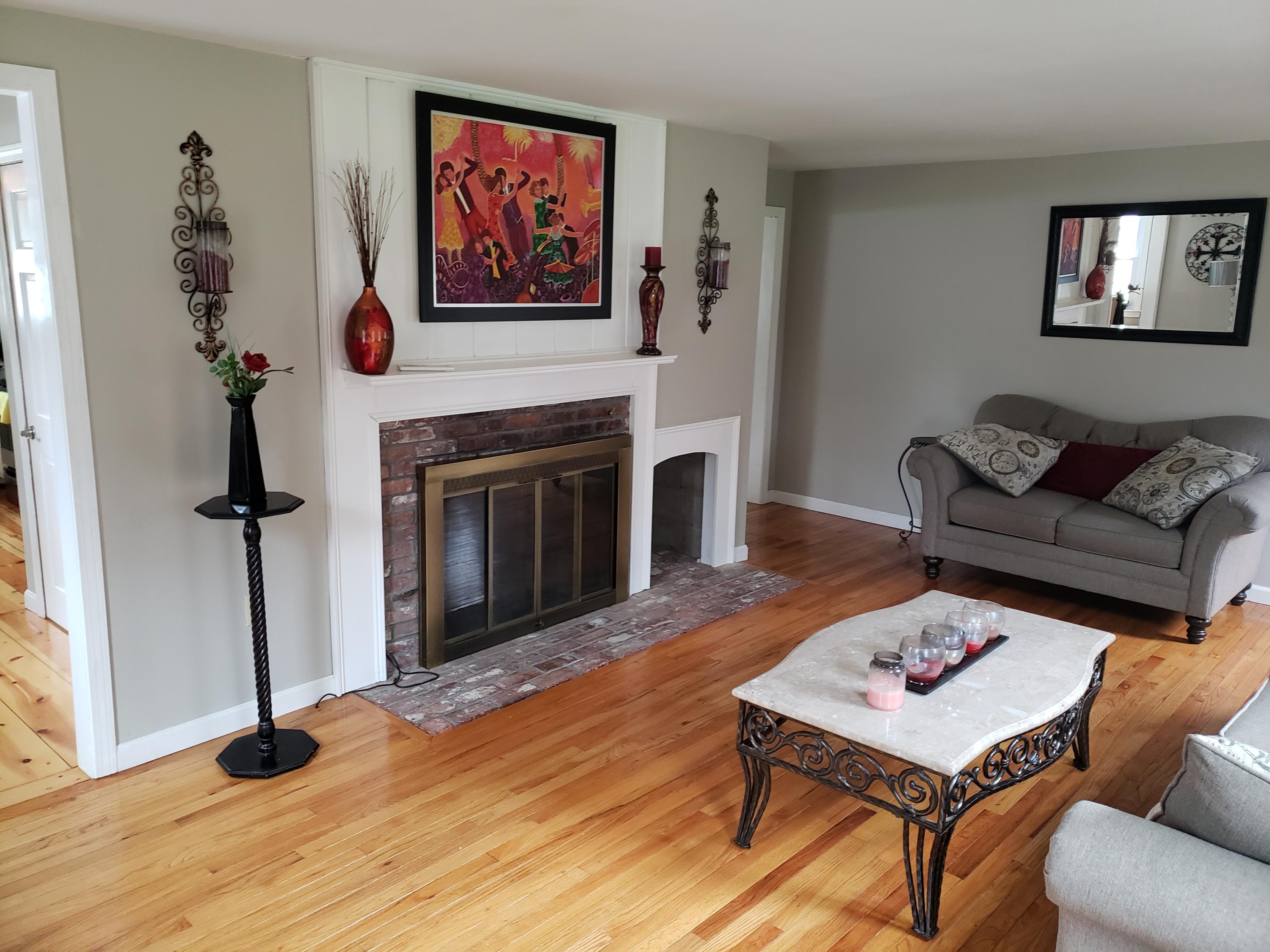 545 Lumbert Mill Road Centerville, MA 02632 - Photo 8 of 27 a living room with furniture and a fireplace