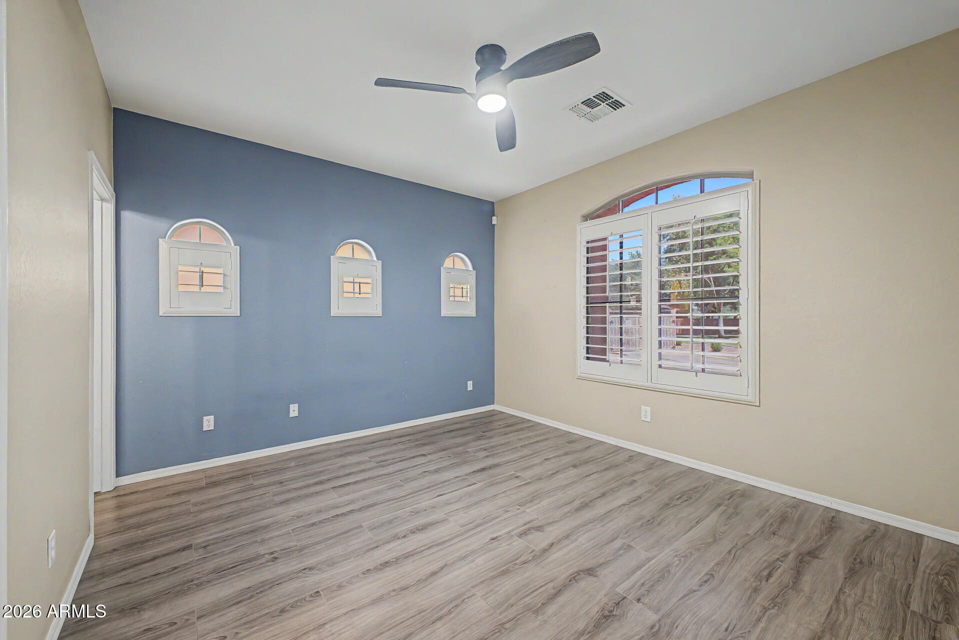 2600 East Springfield Place, Unit 109 Chandler, AZ 85286 - Photo 13 of 38 a view of empty room with wooden floor and fan
