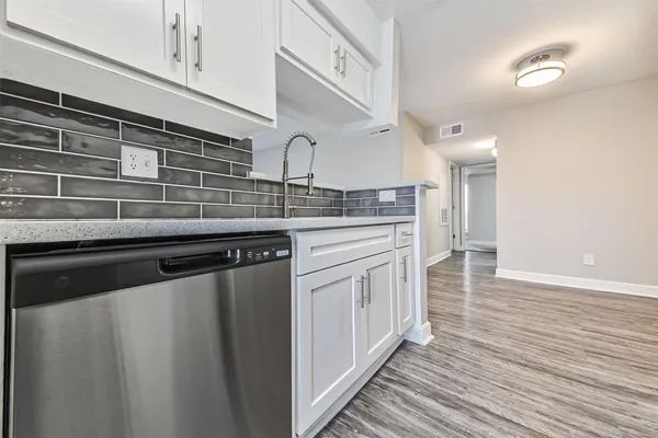 a kitchen with stainless steel appliances granite countertop a sink and cabinets