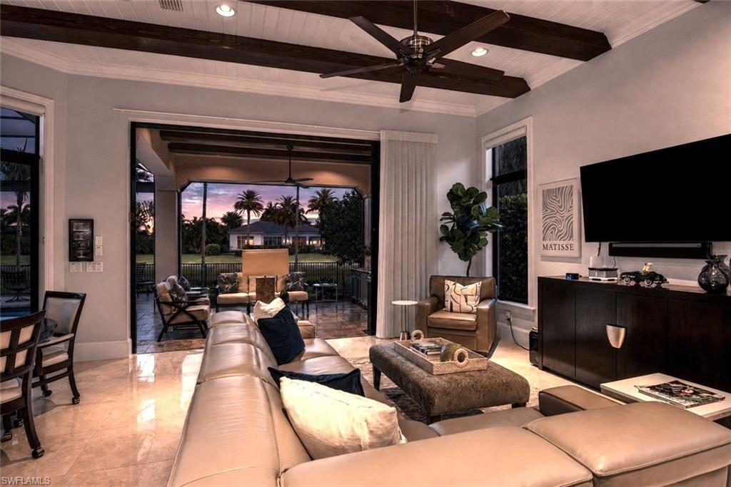 2220 Residence Circle Naples, FL 34105 - Photo 33 of 50 a living room with furniture and a flat screen tv