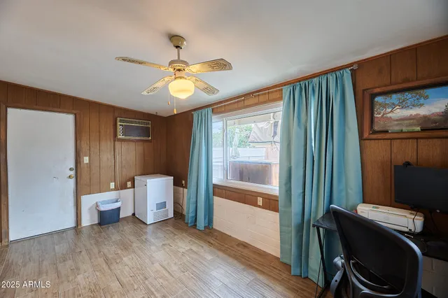 a view of a hallway with bathroom and wooden floor